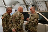 Deputy Commanding General for U.S. Army Reserve Command, Maj. Gen. Gregory J. Mosser (right) speaks with U.S. Army Civil Affairs & Psychological Operations Command (Airborne) Commanding General, Brig. Gen. Jeffrey C. Coggin (left), and USACAPOC(A) Deputy Commanding General, Brig. Gen. Michael M. Greer (center), Aug. 27, 2021. Soldiers from USACAPOC(A) took part in Joint Light Tactical Vehicle (JLTV) introduction training Aug. 23-27, 2021, at the command headquarters, Fort Bragg, N.C., as part of initial JLTV fielding for the command.