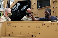 Deputy Commanding General for U.S. Army Reserve Command, Maj. Gen. Gregory J. Mosser (left), speaks with Sgt. Maj. Michael J. Robinson (center), senior enlisted advisor to the USARC Deputy Commanding General, and Jerry Jones (right), project manager for USACAPOC(A) Joint Light Tactical Vehicle (JLTV) New Equipment Fielding (NEF) site, Aug. 27, 2021. Soldiers from USACAPOC(A) took part in JLTV introduction training Aug. 23-27, 2021, at the command headquarters, Fort Bragg, N.C., as part of initial JLTV fielding for the command.