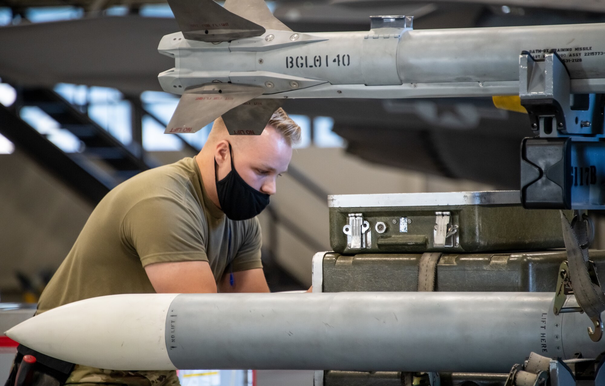 U.S. Air Force Senior Airman Seth Holden from the 419th Aircraft Maintenance Squadron gathers tools to assist team members during a weapons load competition at Hill Air Force Base, Utah on Sept. 24, 2021. The quarterly competition focuses on speed, accuracy, and safety, ensuring standard loading procedures and proficiency across the wings. (U.S. Air Force photo by Senior Airman Erica Webster)