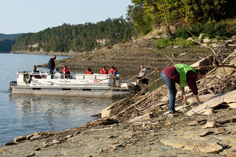 Hailey Heins, sophomore and Jr. ROTC cadet at Pulaski County High School, picks up trash on the shoreline of Lake Cumberland near Burnside, Kentucky, on National Public Lands Day Sept. 25, 2021. (USACE Photo by Lee Roberts)