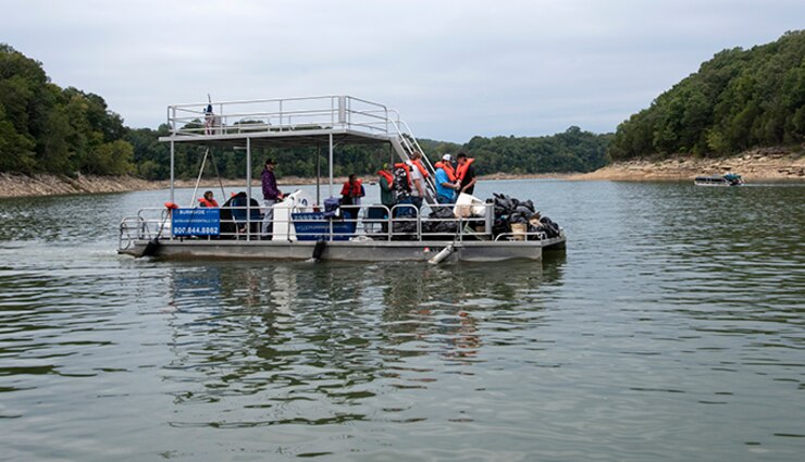 Members of the Pulaski County High School Future Farmers of America organization transport trash to the boat ramp at Burnside Island State Park the group picked up along the Lake Cumberland shoreline Sept. 25, 2021 on National Public Lands Day. The U.S. Army Corps of Engineers Nashville District’s staff at the lake worked with partners and volunteers to pick up tons of trash around the lake. (USACE Photo by Lee Roberts)