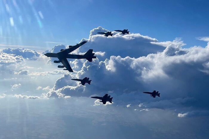 A U.S. Air Force B-52H Stratofortress flies in formation with Spanish air force F-18 aircraft.