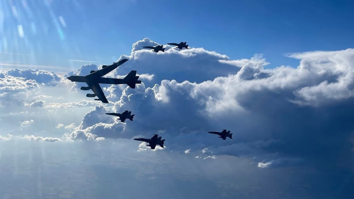 A U.S. Air Force B-52H Stratofortress flies in formation with Spanish air force F-18 aircraft.