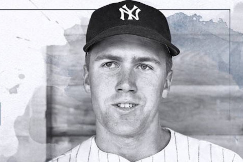 A baseball player poses for a photo.