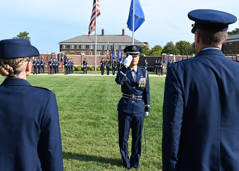 A member of The United States Air Force Honor Guard salutes outgoing Joint Base Anacostia-Bolling and 11th Wing Commander Col. Mike Zuhlsdorf during a change of command ceremony at JBAB, Washington, D.C., Sept. 28, 2021. Zuhlsdorf led the installation through the Department of Defense’s first-ever joint base lead service transfer in 2020, during which the Air Force took control of the installation from the Navy. He relinquished command to incoming commander Col. Cat Logan. (U.S. Air Force photo by Staff Sgt. Kayla White)