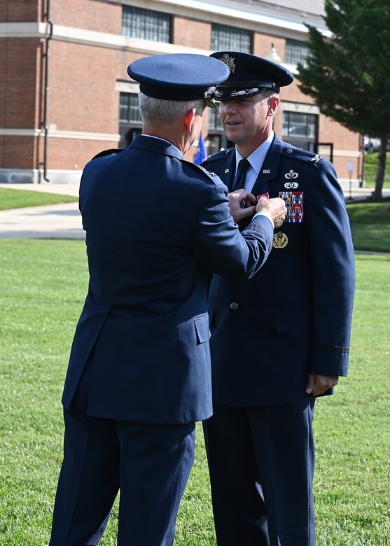 U.S. Air Force Maj. Gen. Joel D. Jackson, Air Force District of Washington and the 320th Air Expeditionary Wing commander, left, presents Col. Mike Zuhlsdorf, outgoing Joint Base Anacostia-Bolling and 11th Wing commander, the Legion of Merit during a change of command ceremony at Joint Base Anacostia-Bolling, Washington, D.C., Sept. 28, 2021. Zuhlsdorf commanded JBAB and the 11th Wing during the Department of Defense’s first-ever joint base lead service transfer in 2020, during which the Air Force took control of the installation from the Navy. Zuhlsdorf relinquished command to incoming commander Col. Cat Logan. (U.S. Air Force photo by Staff Sgt. Kayla White)