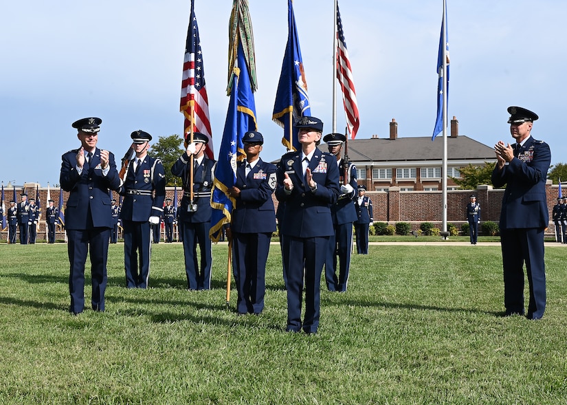 U.S. Air Force Maj. Gen. Joel D. Jackson, Air Force District of Washington and the 320th Air Expeditionary Wing commander, and outgoing Joint Base Anacostia-Bolling and 11th Wing Commander Col. Mike Zuhlsdorf applaud incoming commander Col. Cat Logan during a change of command ceremony at JBAB, Washington, D.C., Sept. 28, 2021. Logan took command from Col. Mike Zuhlsdorf, making her the first female commander of JBAB and the 11th Wing and the second commander of the wing at JBAB since the Air Force wing took authority of the installation during the Department of Defense’s first-ever joint base service lead transfer in 2020. (U.S. Air Force photo by Staff Sgt. Kayla White)