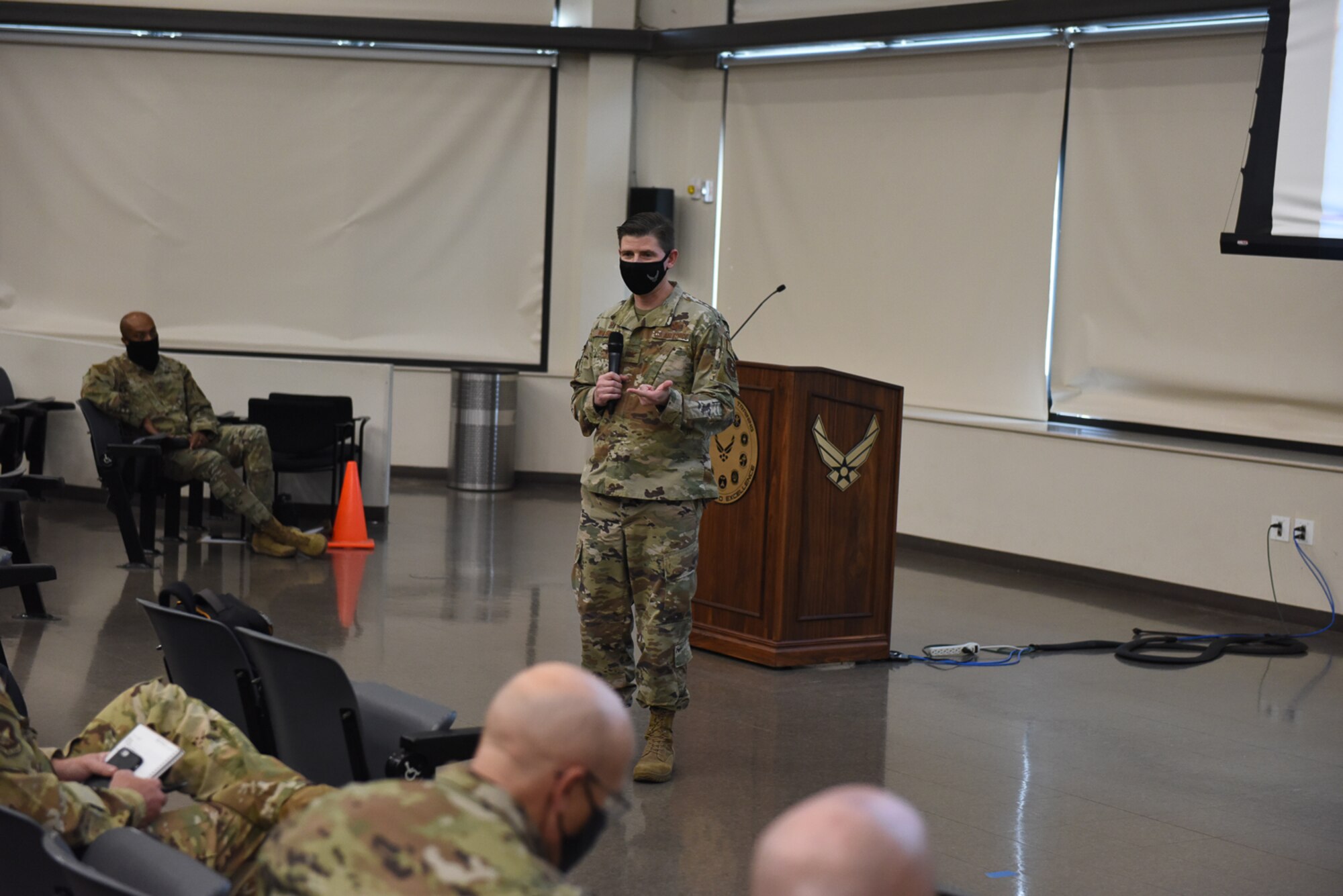 37th TRW commander speaks in front of conference attendees.
