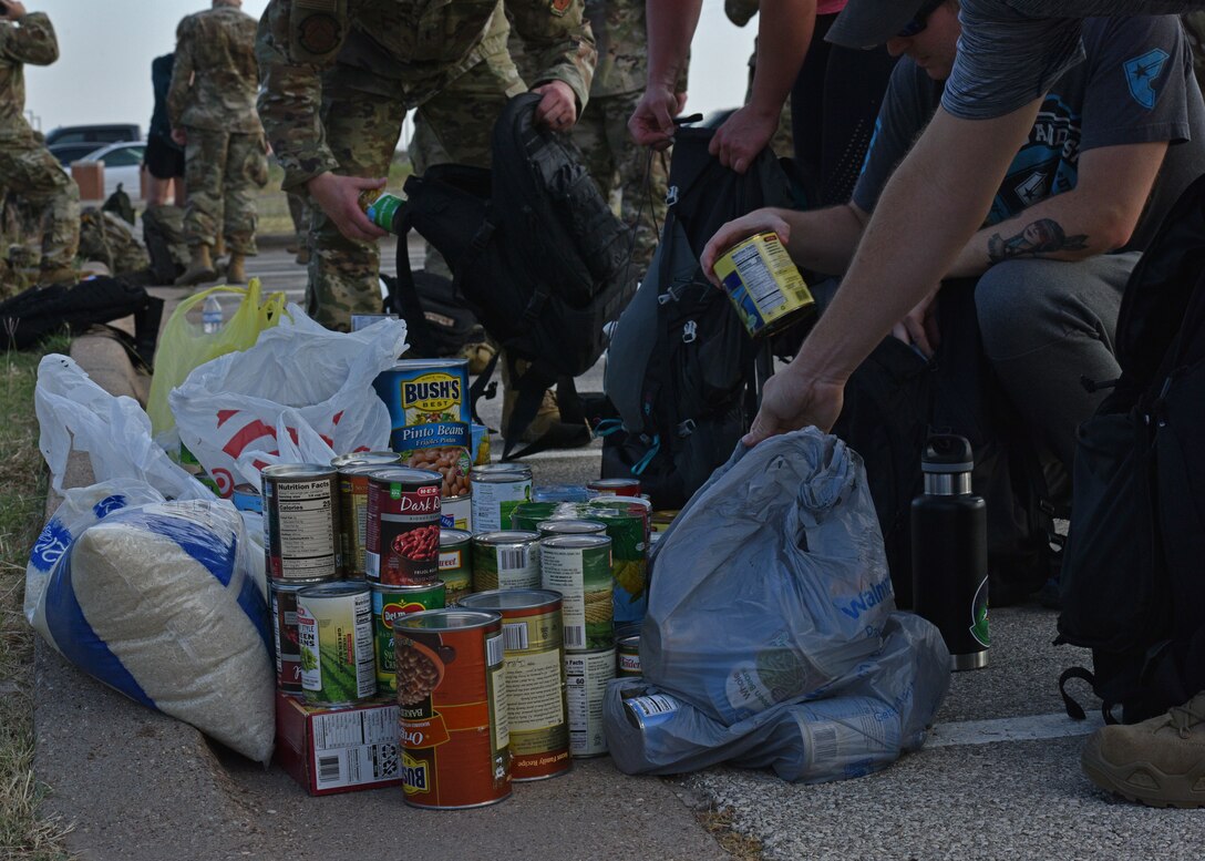 Goodfellow members donate canned goods at the annual Jacobson Ruck March on Goodfellow Air Force Base, Texas, Sept. 28, 2021. Each member filled their rucksacks with cans to donate to the local food bank. (U.S. Air Force photo by Senior Airman Ashley Thrash)