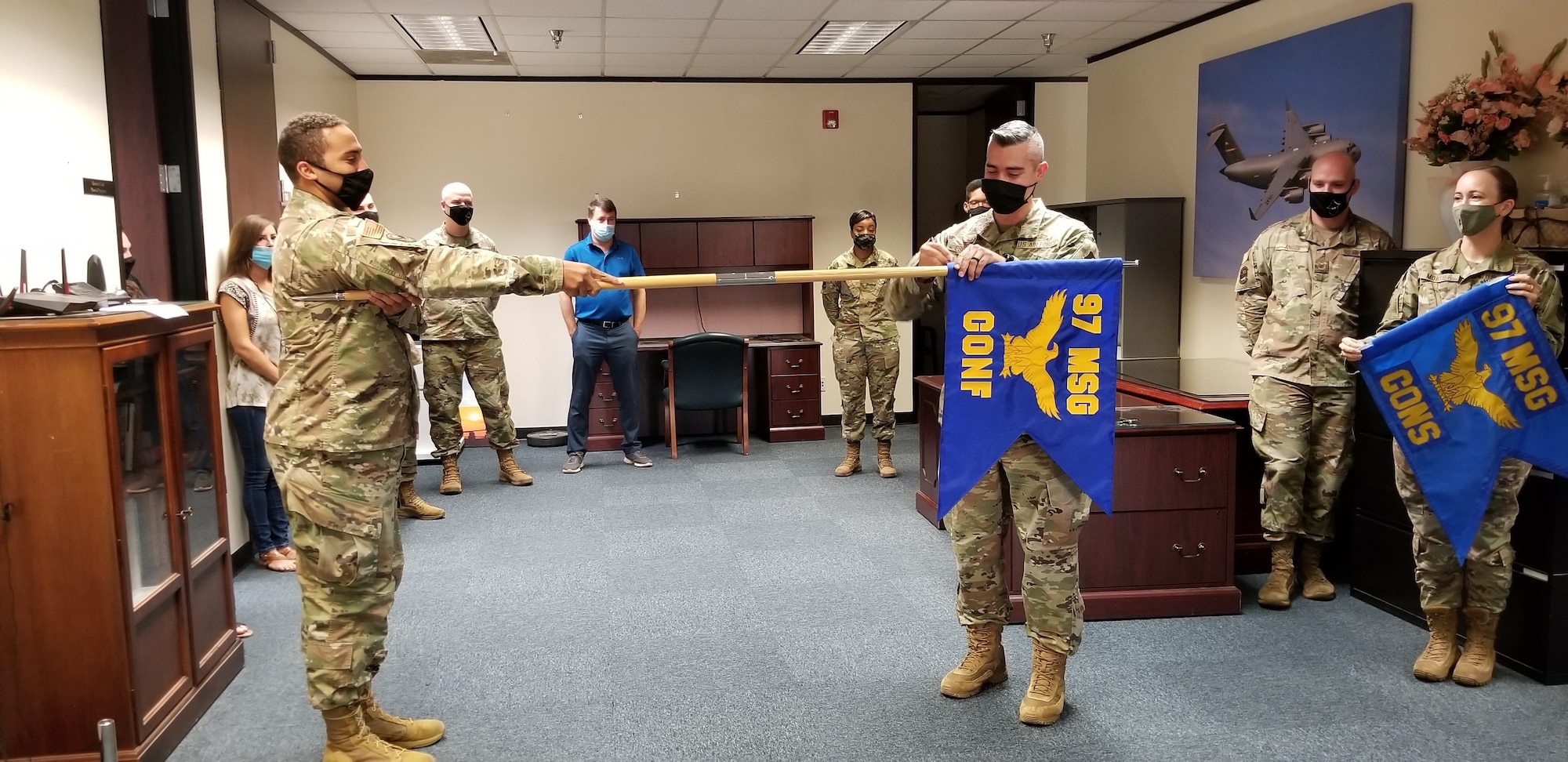 Maj. Jonathan Esquivel, 97th Contracting Squadron (CONS) commander, removes the 97th Contracting Flight flag at Altus Air Force Base, Oklahoma, Aug. 3, 2021. The 97th CONS is split into three flights: the base support flight, construction flight, and infrastructure flight. (Courtesy photo by Lori Clinton)