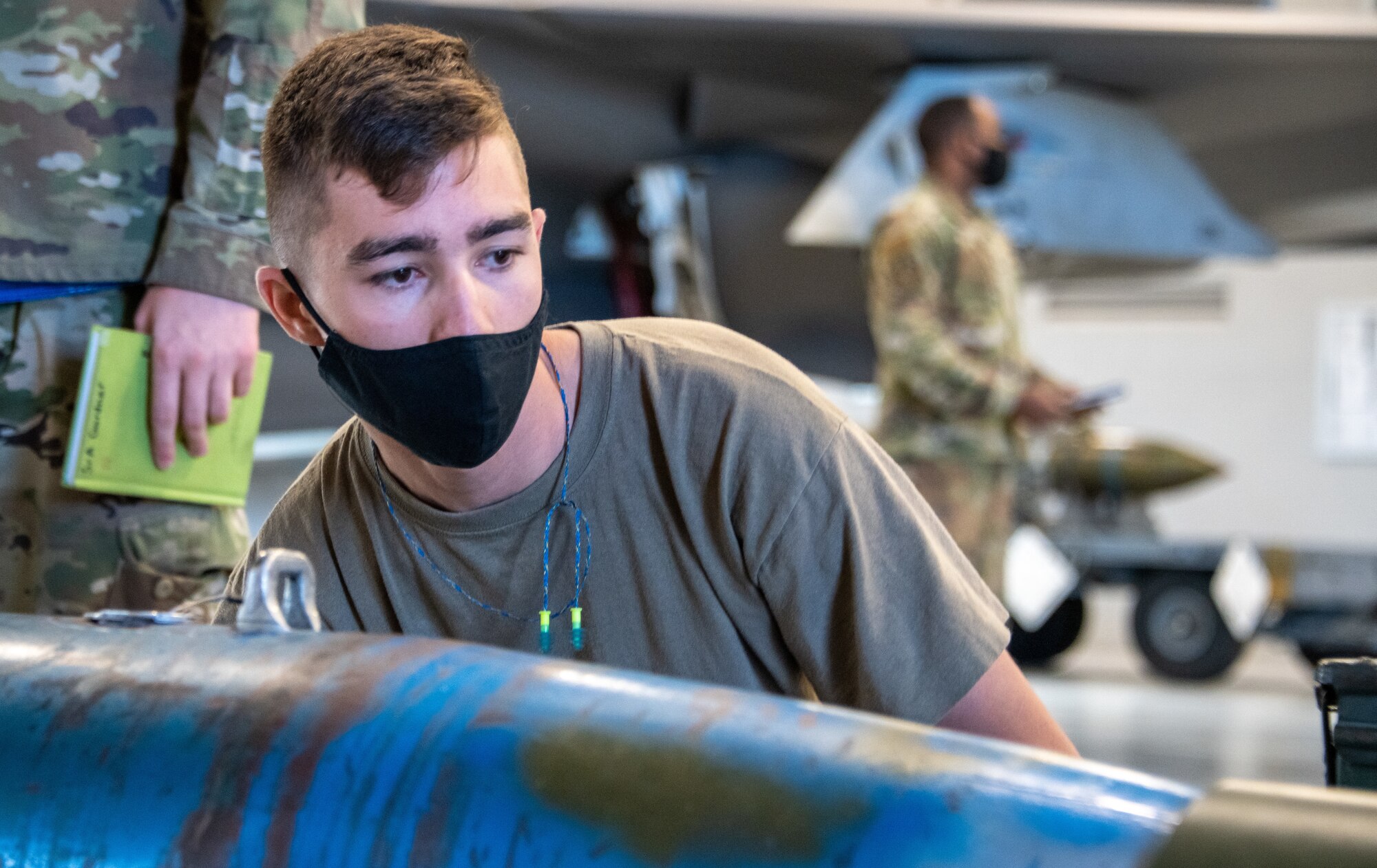 U.S. Air Force Staff Sgt. Connor Hansen from the 419th Aircraft Maintenance Squadron inspects an unarmed GBU-12 Pave Way bomb during a weapons load competition at Hill Air Force Base, Utah on Sept. 24, 2021. The quarterly competition focuses on speed, accuracy and safety, and ensures standard loading procedures and proficiency across the wings. (U.S. Air Force photo by Senior Airman Erica Webster)