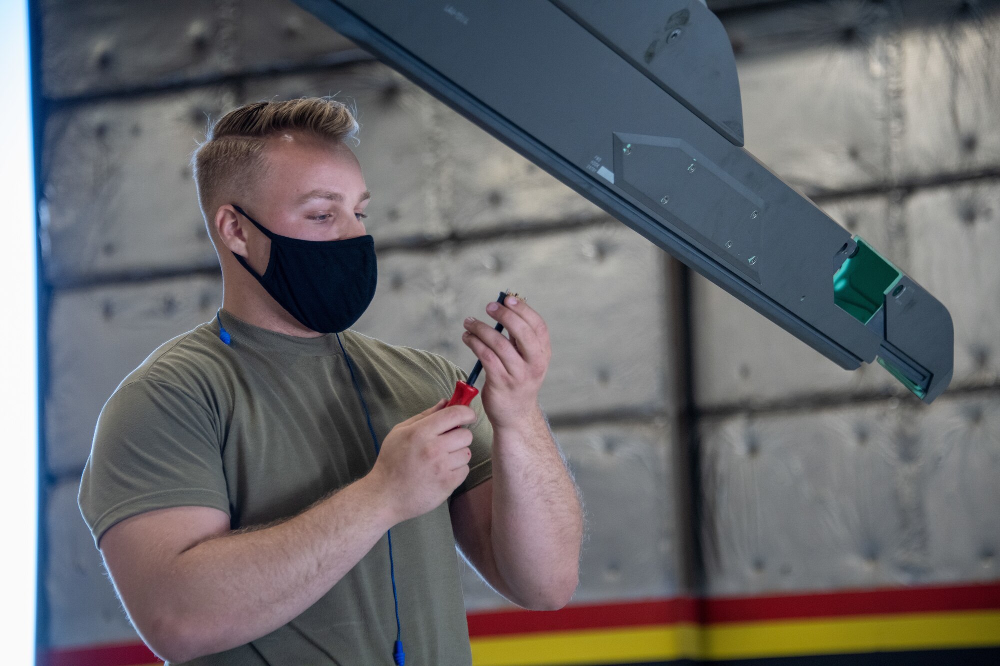 U.S. Air Force Senior Airman Seth Holden from the 419th Aircraft Maintenance Squadron prepares a pylon on an F-35A Lightning II during a weapons load competition at Hill Air Force Base, Utah on Sept. 24, 2021. The quarterly competition focuses on speed, accuracy, and safety, ensuring standard loading procedures and proficiency across the wings. (U.S. Air Force photo by Senior Airman Erica Webster)
