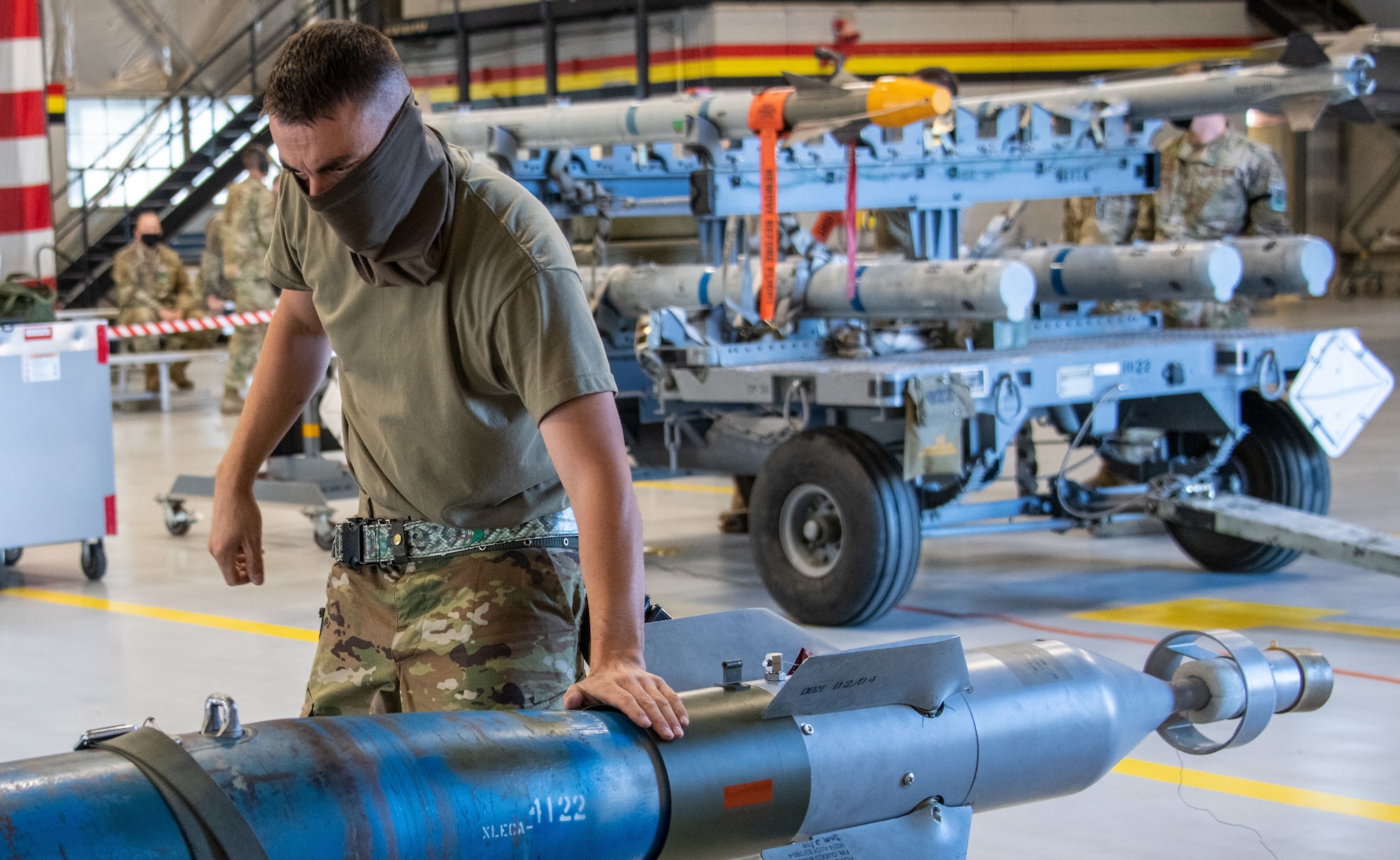 U.S. Air Force Master Sgt. Jonathan Thorsted from the 419th Aircraft Maintenance Squadron ensures an unarmed GBU-12 Pave Way bomb is properly secured before loading it onto an F-35A Lightning II during a weapons load competition at Hill Air Force Base, Utah on Sept. 24, 2021. The quarterly competition focuses on speed, accuracy, and safety, ensuring standard loading procedures and proficiency across the wings. (U.S. Air Force photo by Senior Airman Erica Webster)