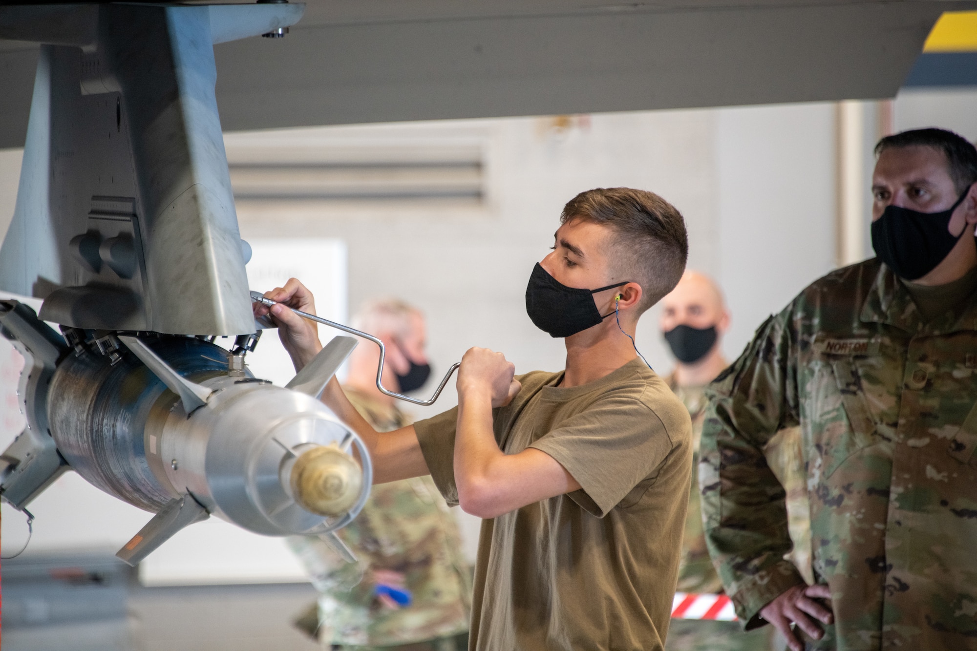 U.S. Air Force Staff Sgt. Connor Hansen from the 419th Aircraft Maintenance Squadron secures an unarmed bomb to an F-35A Lightning II aircraft during a weapons load competition at Hill Air Force Base, Utah on Sept. 24, 2021. The quarterly competition focuses on speed, accuracy, and safety, ensuring standard loading procedures and proficiency across the wings. (U.S. Air Force photo by Senior Airman Erica Webster)