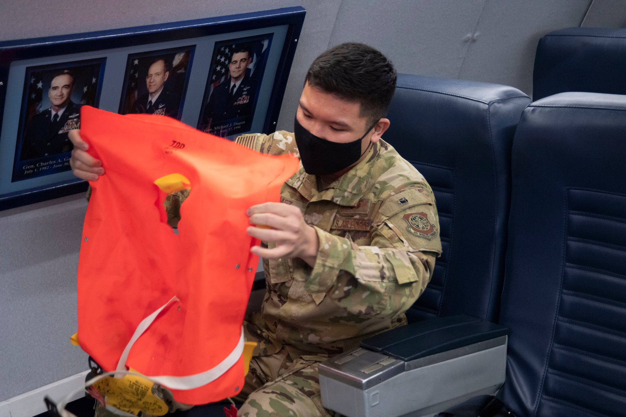 Flight Attendant Course student puts on life vest
