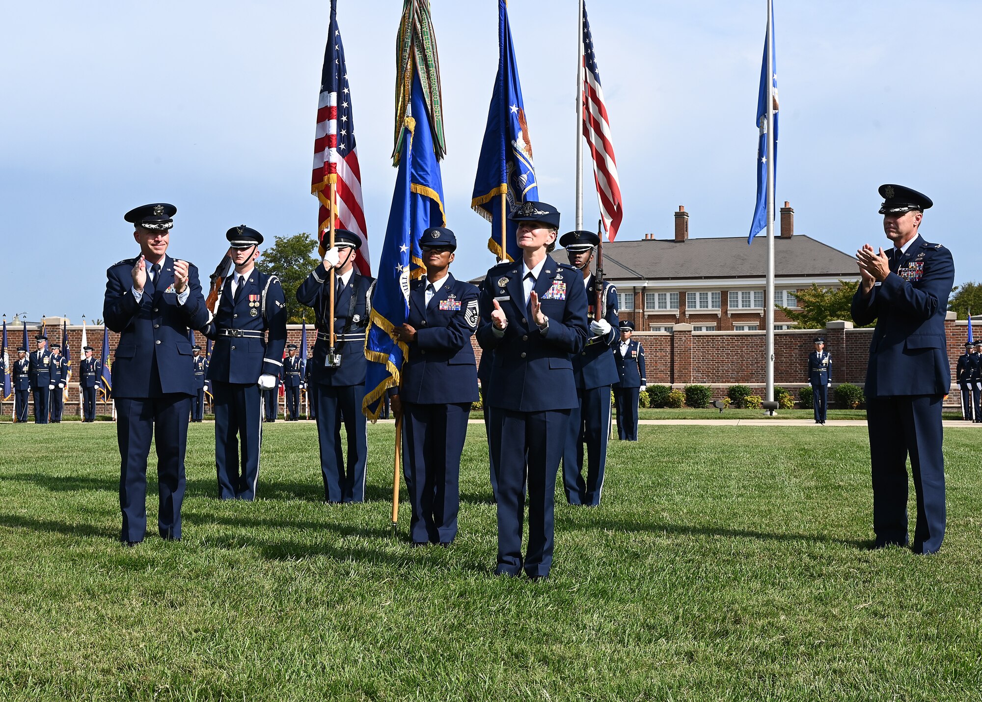 U.S. Air Force Maj. Gen. Joel D. Jackson, Air Force District of Washington and the 320th Air Expeditionary Wing commander, and outgoing Joint Base Anacostia-Bolling and 11th Wing Commander Col. Mike Zuhlsdorf applaud incoming commander Col. Cat Logan during a change of command ceremony at JBAB, Washington, D.C., Sept. 28, 2021. Logan took command from Col. Mike Zuhlsdorf, making her the first female commander of JBAB and the 11th Wing and the second commander of the wing at JBAB since the Air Force wing took authority of the installation during the Department of Defense’s first-ever joint base service lead transfer in 2020. (U.S. Air Force photo by Staff Sgt. Kayla White)