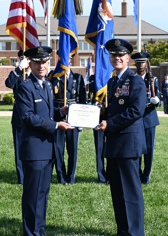 U.S. Air Force Maj. Gen. Joel D. Jackson, Air Force District of Washington and the 320th Air Expeditionary Wing commander, left, presents Col. Mike Zuhlsdorf, outgoing Joint Base Anacostia-Bolling and 11th Wing commander, the Legion of Merit during a change of command ceremony at Joint Base Anacostia-Bolling, Washington, D.C., Sept. 28, 2021. Zuhlsdorf commanded JBAB and the 11th Wing during the Department of Defense’s first-ever joint base lead service transfer in 2020, during which the Air Force took control of the installation from the Navy. Zuhlsdorf relinquished command to incoming commander Col. Cat Logan. (U.S. Air Force photo by Staff Sgt. Kayla White)