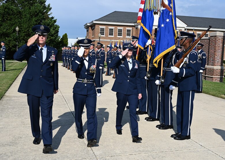 U.S. Air Force Col. Mike Zuhlsdorf, left, and Col. Cat Logan, right, respectively the outbound and inbound commanders of Joint Base Anacostia-Bolling and the 11th Wing, salute during a ceremonial inspection of a United States Air Force Honor Guard formation during a change of command ceremony at Joint Base Anacostia-Bolling, Washington, D.C., Sept. 28, 2021. Zuhlsdorf commanded JBAB and the 11th Wing through the Department of Defense’s first-ever joint base lead service transfer in 2020, during which the Air Force took command of the installation from the Navy. He relinquished command to incoming commander Col. Cat Logan, who became the first female commander of JBAB and the 11th Wing. (U.S. Air Force photo by Staff Sgt. Kayla White)