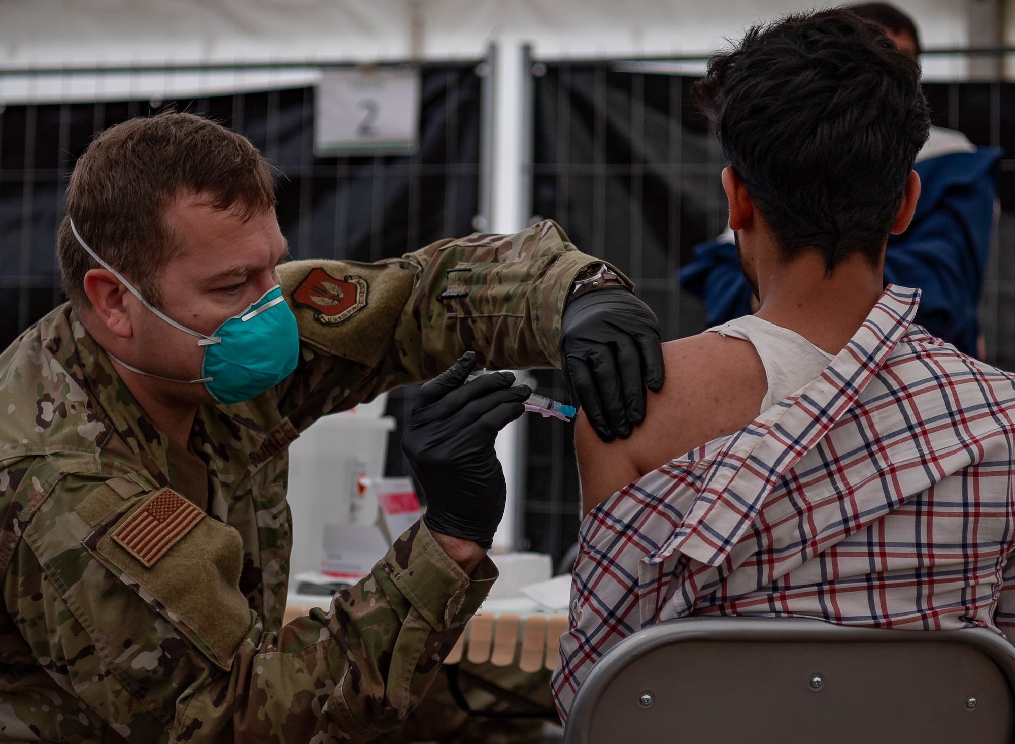 Evacuee receives vaccine.
