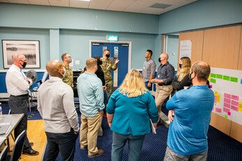 Emergency Management professionals collaborate during an Operational Planning team meeting at RAF Alconbury, England, Sept. 28, 2021. The meeting was intended to provide a foundation and framework for command & control operations and reporting within the 501st Combat Support Wing as well as critical communication connection to mission partners. During the meeting EM members worked together to develop an organizational C2 process that establishes a defined wing-wide network across all 501 CSW installations and organizations including mission partners and geographically separated units. (U.S. Air Force photo by Senior Airman Eugene Oliver)