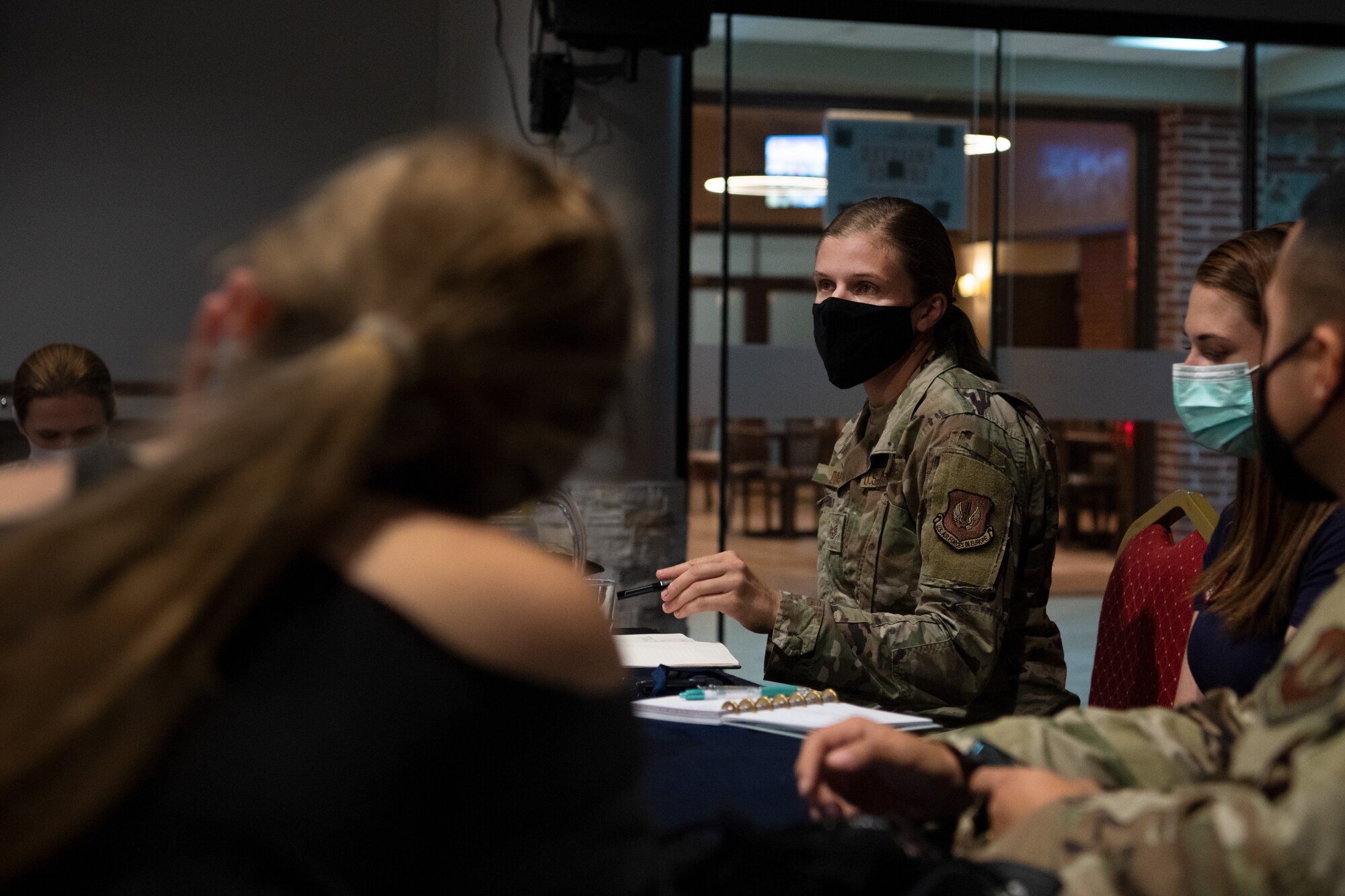 female soldier leads Pride Committee meeting