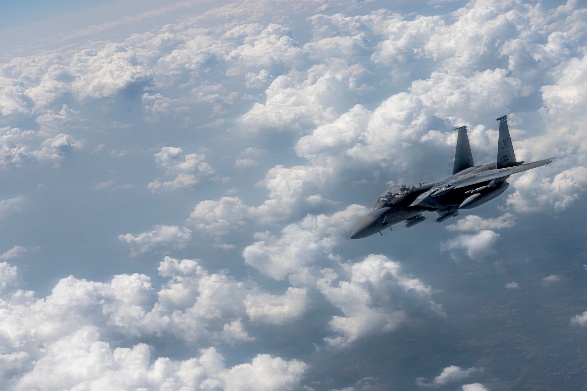 An F-15E Strike Eagle assigned to the 494th Expeditionary Fighter Squadron banks