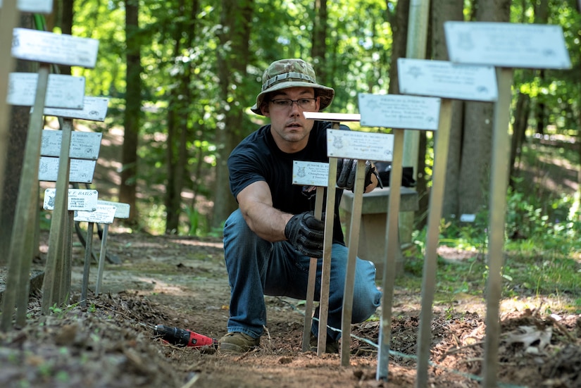 Pennsylvania Air National Guard, Master Sgt. William Davis, a vehicle maintenance specialist with the 270th Engineering Installation Squadron here, lines up plaques at the Medal of Honor Grove, Freedoms Foundation, Valley Forge, Pennsylvania,  June 16, 2021. The 111th Guardsmen volunteered to help clean, organize, and remove debris with the Friends of the Medal of Honor Grove, an all-volunteer group that maintains the Medal of Honor Grove.
