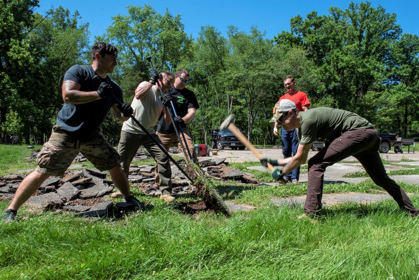 Pennsylvania Air National Guardsmen with the 111th Attack Wing, headquartered in Horsham, Pennsylvania, break up blacktop at the Medal of Honor Grove, Freedoms Foundation, Valley Forge Pennsylvania,  June 16, 2021. The 111th Guardsmen volunteered to help clean, organize, and remove debris with the Friends of the Medal of Honor Grove, an all-volunteer group that maintains the Medal of Honor Grove.