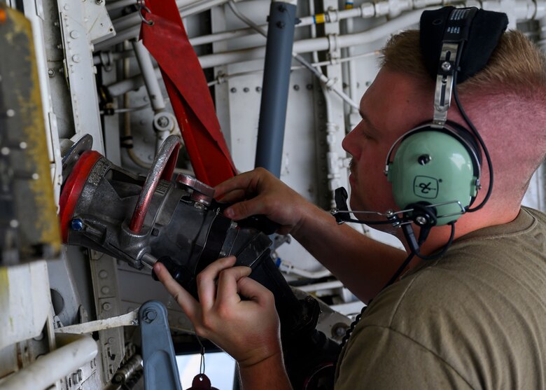 U.S. Air Force Senior Airman Colin Forsyth, 121st Expeditionary Fighter Generation Squadron F-16 crew chief, performs a hot pit refueling on a U.S. Air Force KC-135 Stratotanker at Al Udeid Air Base, Qatar, Aug. 4, 2021. Hot pit refueling is where maintainers refuel an aircraft while the engine is still running, allowing the aircraft to safely and quickly return to flying. This refueling tactic is one of several agile combat employment capabilities the 378th Air Expeditionary Wing demonstrated while in Qatar for Exercise Sky Shield III, a bilateral defensive counter air and combat search and rescue exercise. (U.S. Air Force Photo by Senior Airman Samuel Earick)