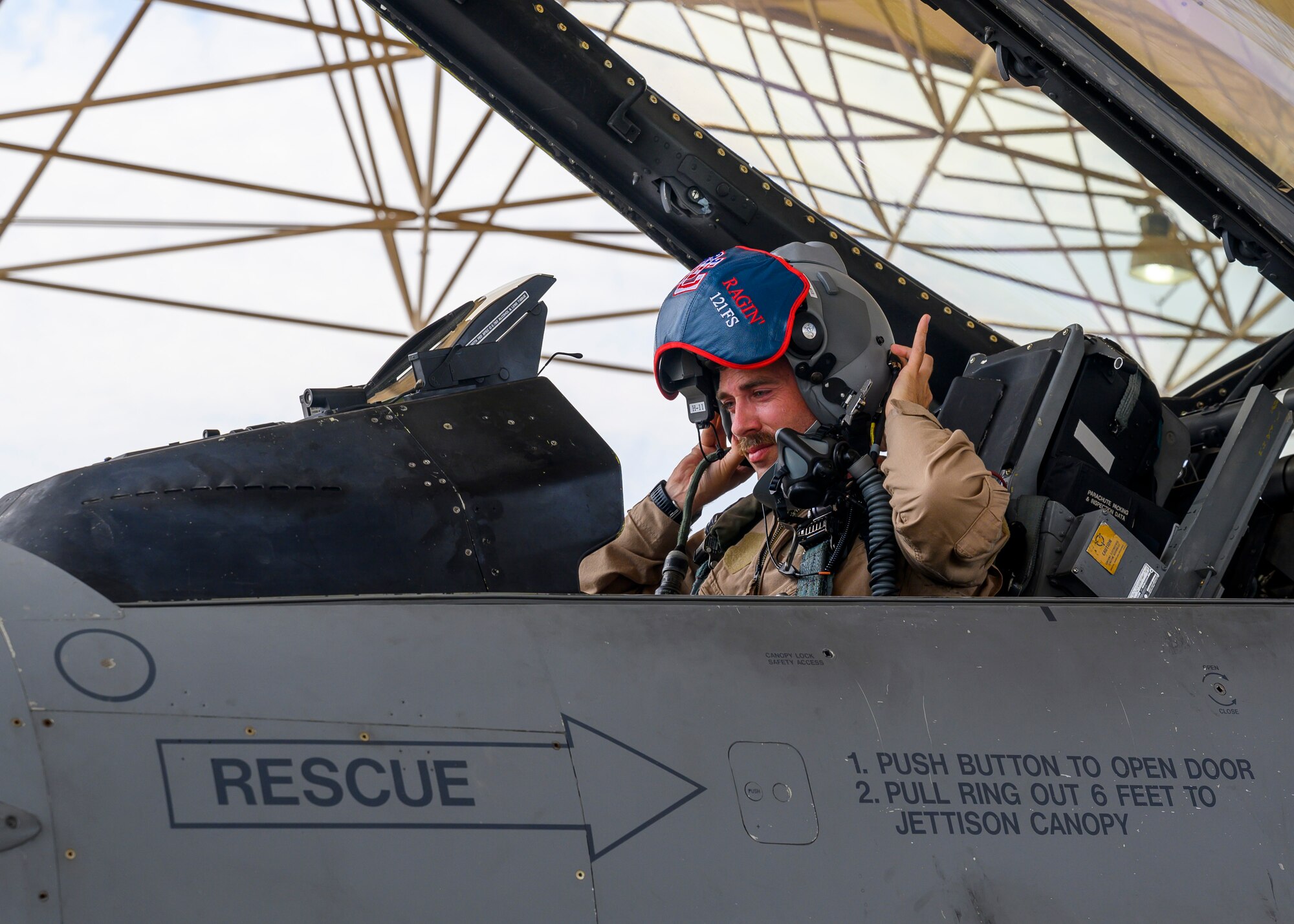 A U.S. Air Force F-16 pilot assigned to the 121st Expeditionary Fighter Squadron adjusts his helmet prior to takeoff during Exercise Sky Shield III at Al Udeid Air Base, Qatar, Aug. 3, 2021. Sky Shield is a bilateral defensive counter air and combat search and rescue exercise designed to validate U.S. Air Forces Central and Qatar Emiri Air Force’s combined capability to defend regional airspace. The event allowed the 378th Air Expeditionary Wing to demonstrate its agile combat employment capabilities of repositioning forces in various locations and rapidly generating combat airpower. (U.S. Air Force photo by Senior Airman Samuel Earick)