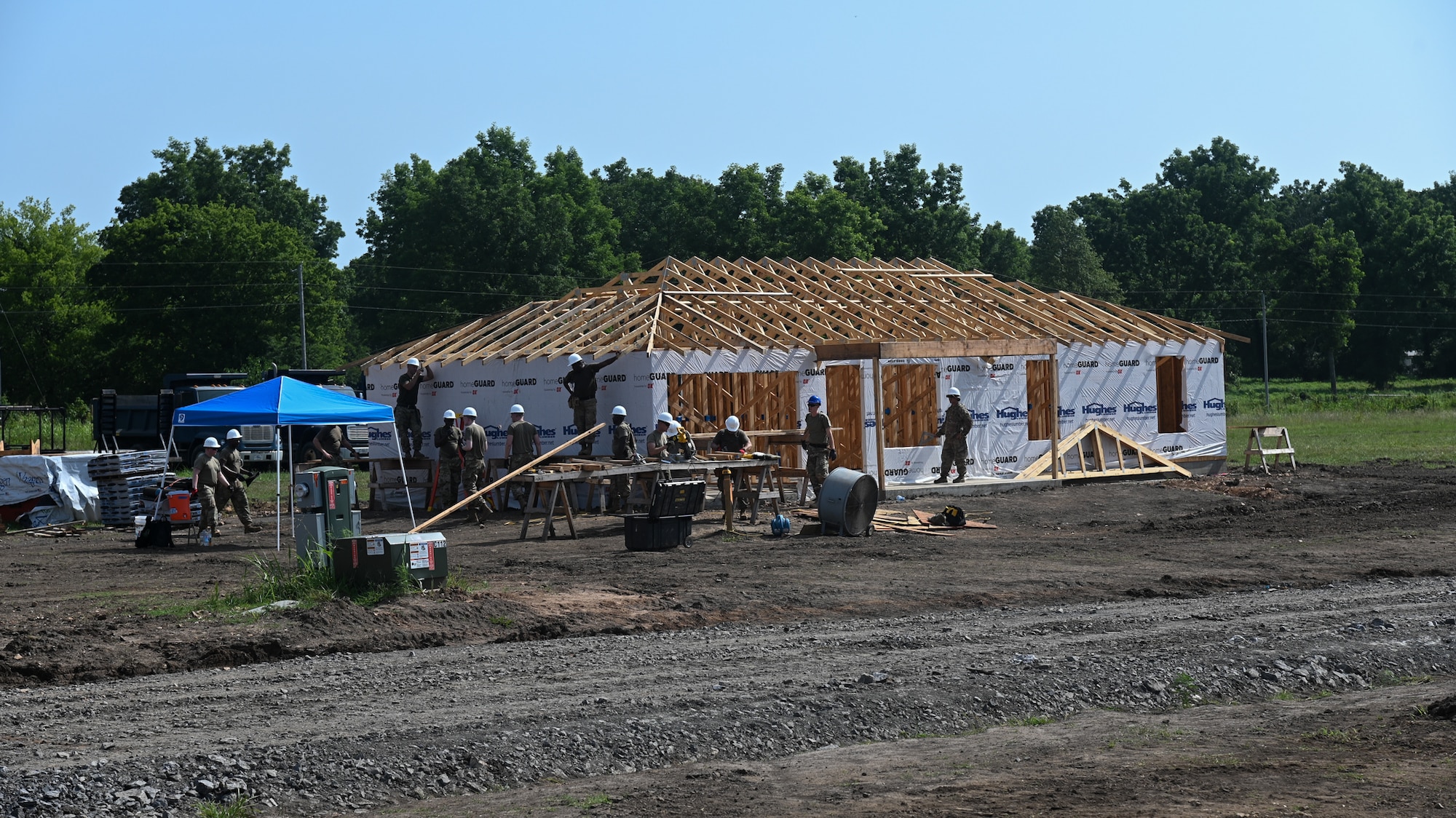 Members from the 175th Wing, Maryland Air National Guard, and the 123rd Airlift Wing, Kentucky Air National Guard, build a home for Cherokee veterans in Tahlequah, Oklahoma, Aug. 3, 2021, as part of the Defense Department’s Innovative Readiness Training program.
