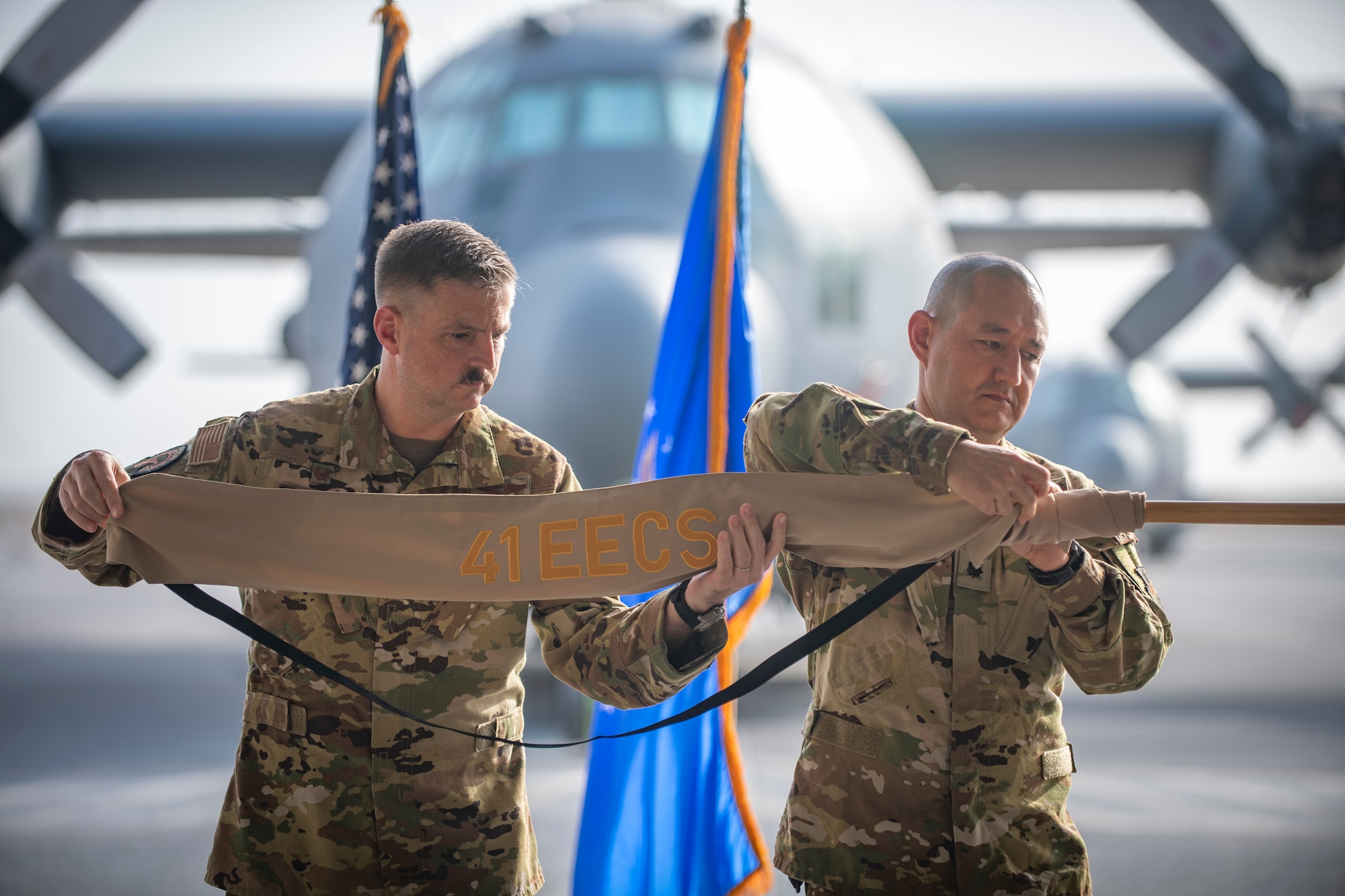 Two men put case on flag