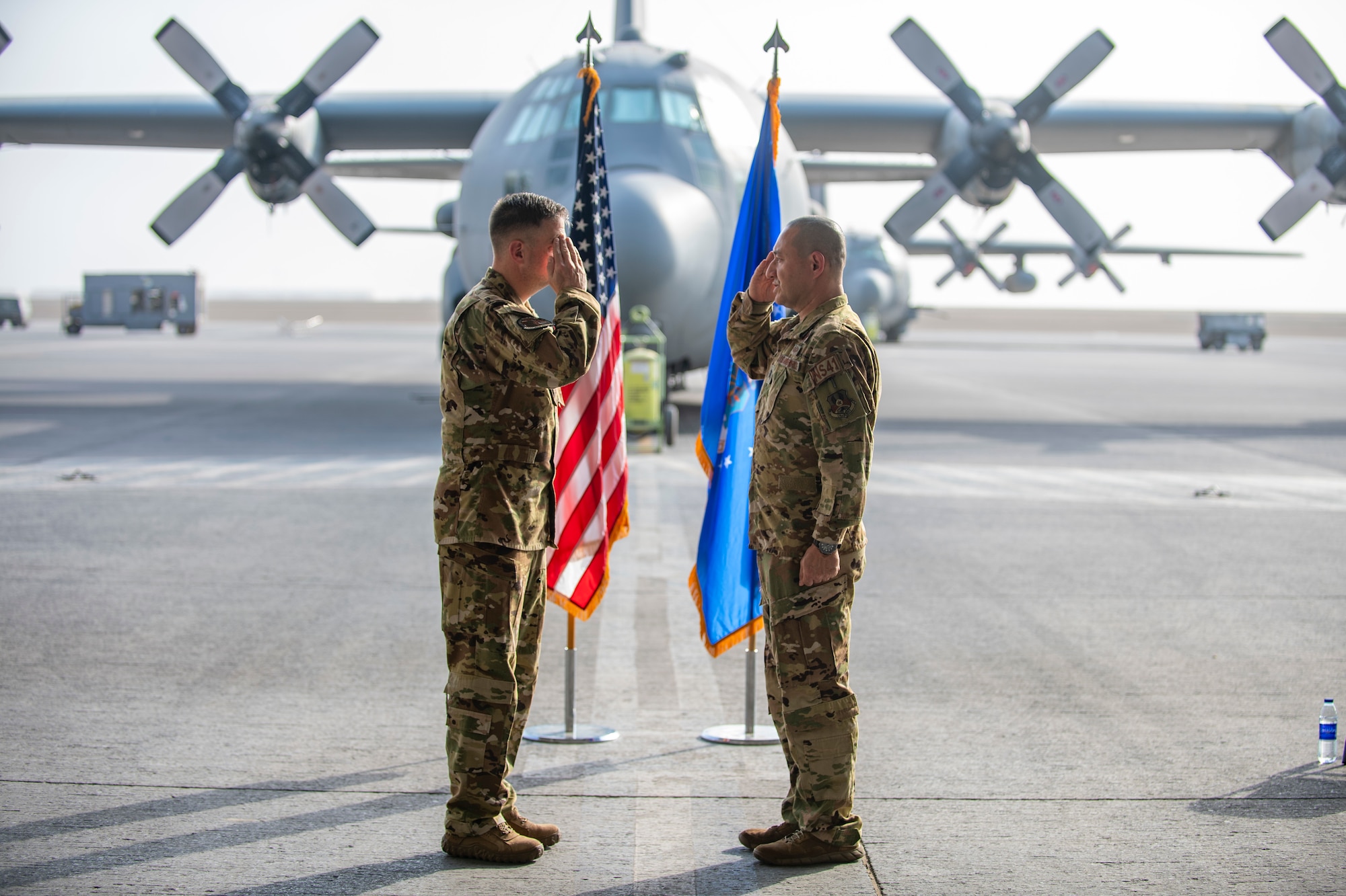 Two men exchange salutes during ceremony