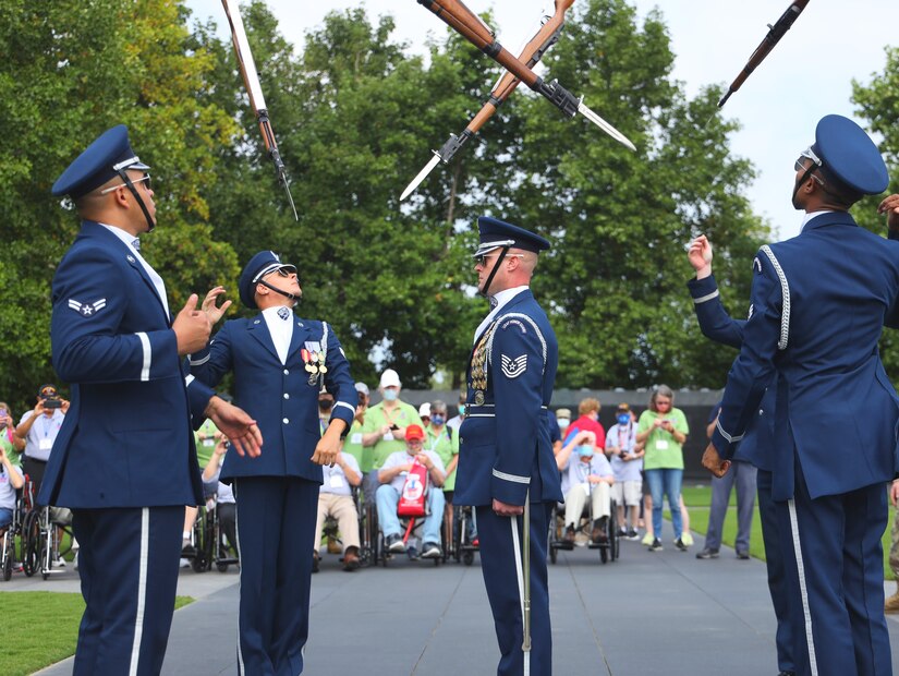 U.S. Air Force Honor Guard Drill Team members toss their M-1 Garand rifles into the air during a performance for Honor Flight Chicago veterans at the Air Force Memorial, Arlington, Va., Sept. 16, 2021. The Honor Flight Network offers American military veterans free transportation to the nation's memorials in Washington, D.C. The group was made up veterans of World War II, the Korean War, and the Vietnam War. (U.S. Air Force photo by Brian Nestor)