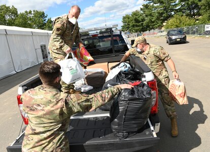 Washington Air National Guard Chief Master Sgt. Marvin Boyd, center, assigned to Washington Air National Guard Headquarters, Camp Murray, Wash., and the senior enlisted leader overseeing Liberty Village 3, helps unload donated items from New Jersey residents, Joint Base McGuire-Dix-Lakehurst, New Jersey, Sept. 20, 2021.  The Department of Defense, through U.S. Northern Command, and in support of the Department of Homeland Security, is providing transportation, temporary housing, medical screening, and general support for at least 50,000 Afghan evacuees at facilities across the nation.