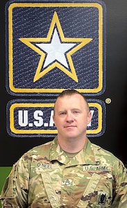 man wearing army uniform with a graphic background.