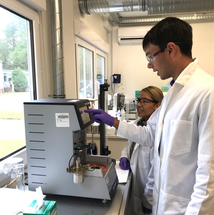 two people in lab coats using testing equipment