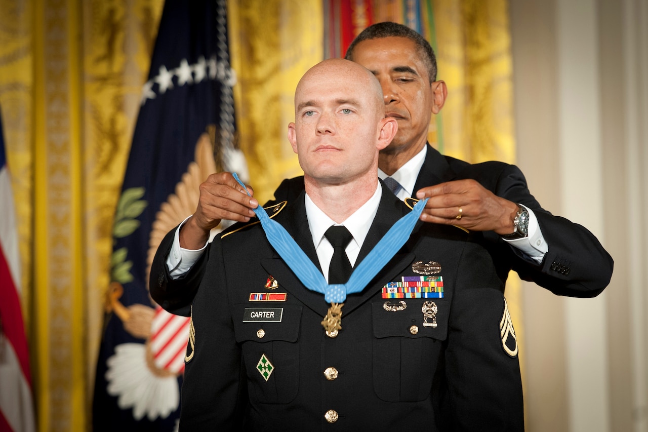 A soldier had a medal placed around his neck.