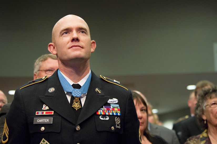 A soldier looks up during a ceremony.