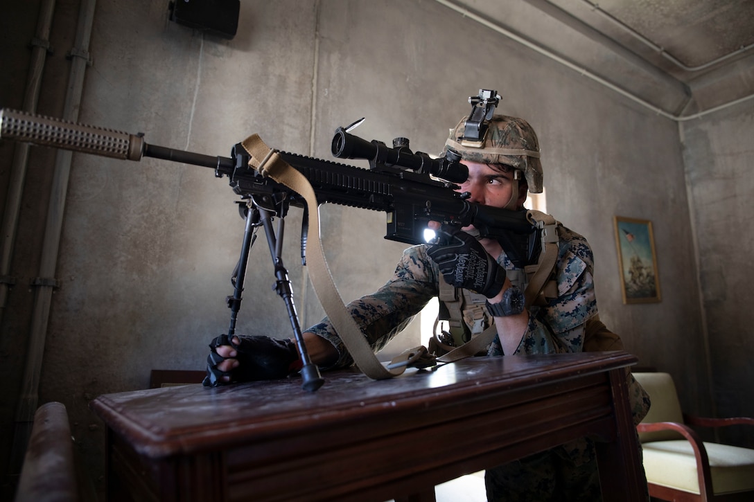 U.S. Marine Corps Lance Cpl. Tristen Crowell, a team leader with 3rd Battalion, 3rd Marines holds security inside a secured building during military operations in urban terrain training on Marine Corps Training Area Bellows, Hawaii Sept. 24, 2021. The training was conducted to increase unit lethality and improve tactical decision making skills in offensive and defensive operations.