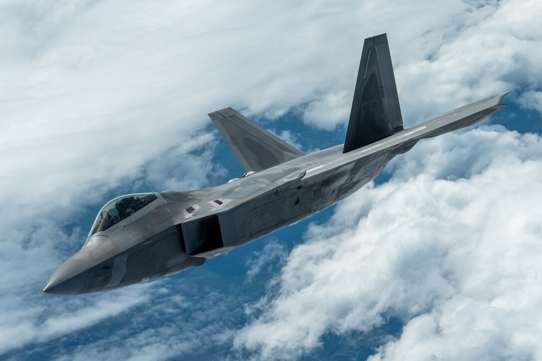 F-22 Demo Team commander, flies next to a KC-135 Stratotanker during an aerial refueling mission