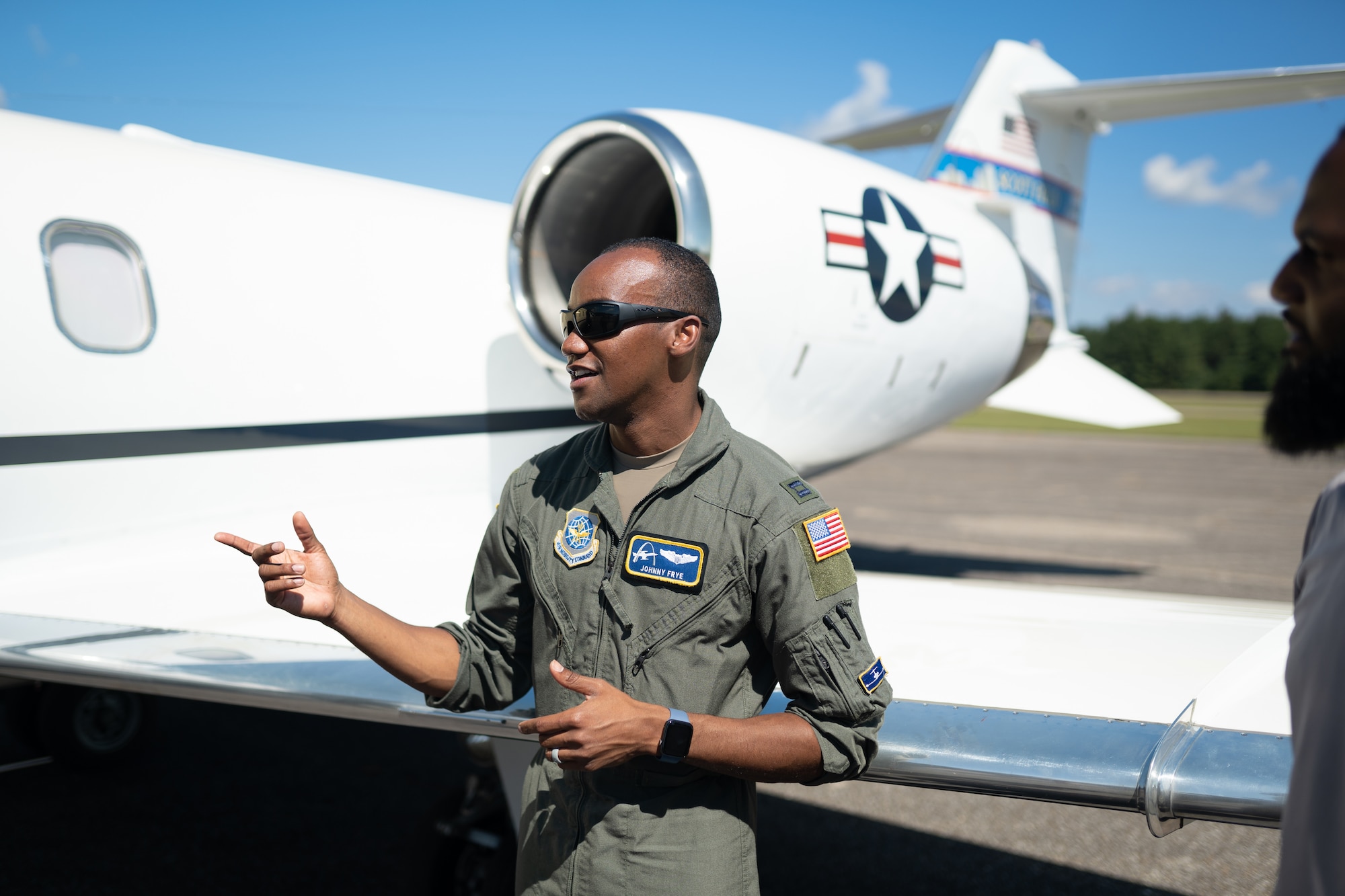 U.S. Air Force Capt. Johnny Frye, 458th Airlift Squadron, C-21 pilot, leads a tour of the aircraft during a visit to Tuskegee, Alabama, Sept. 28, 2021. The group of pilots from Scott AFB, Illinois made history as being the first all-African American crew to land the C-21 at Alabama's historic Tuskegee Airfield. (U.S. Air Force photo by 1st Lt. Sam Eckholm)