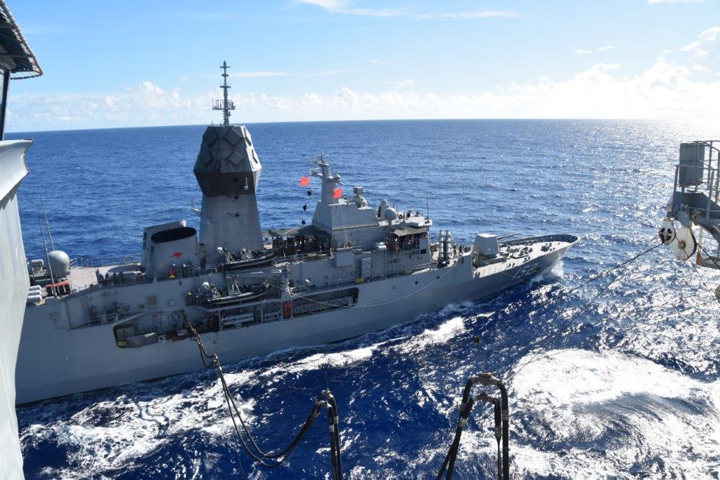 USNS Yukon (T-AO 202) resupplies the Royal Australian Navy Anzac-class frigate HMAS Warramunga (FFH 152), in the Philippine Sea during MALABAR 21.