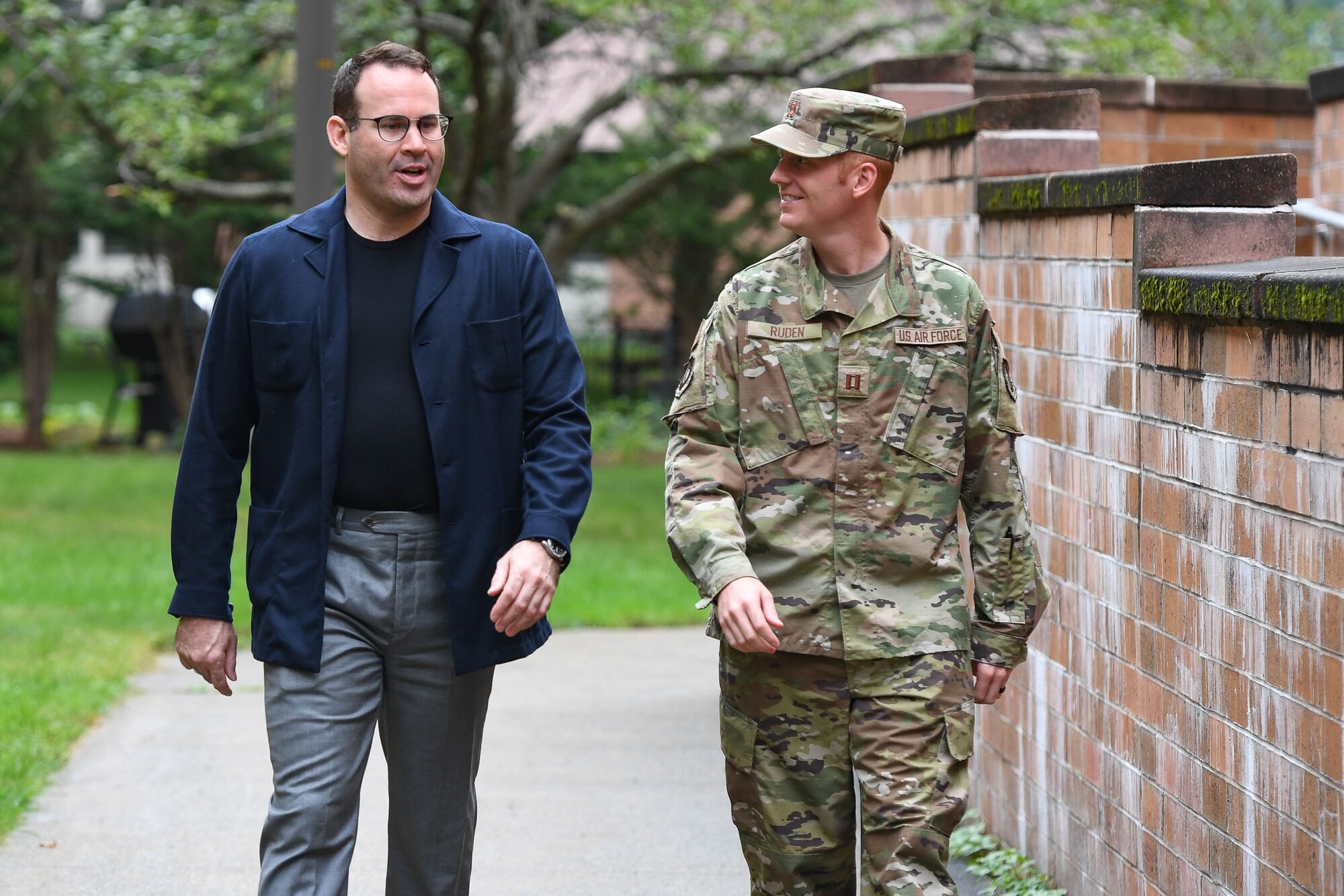 Airman and civilian walking outside