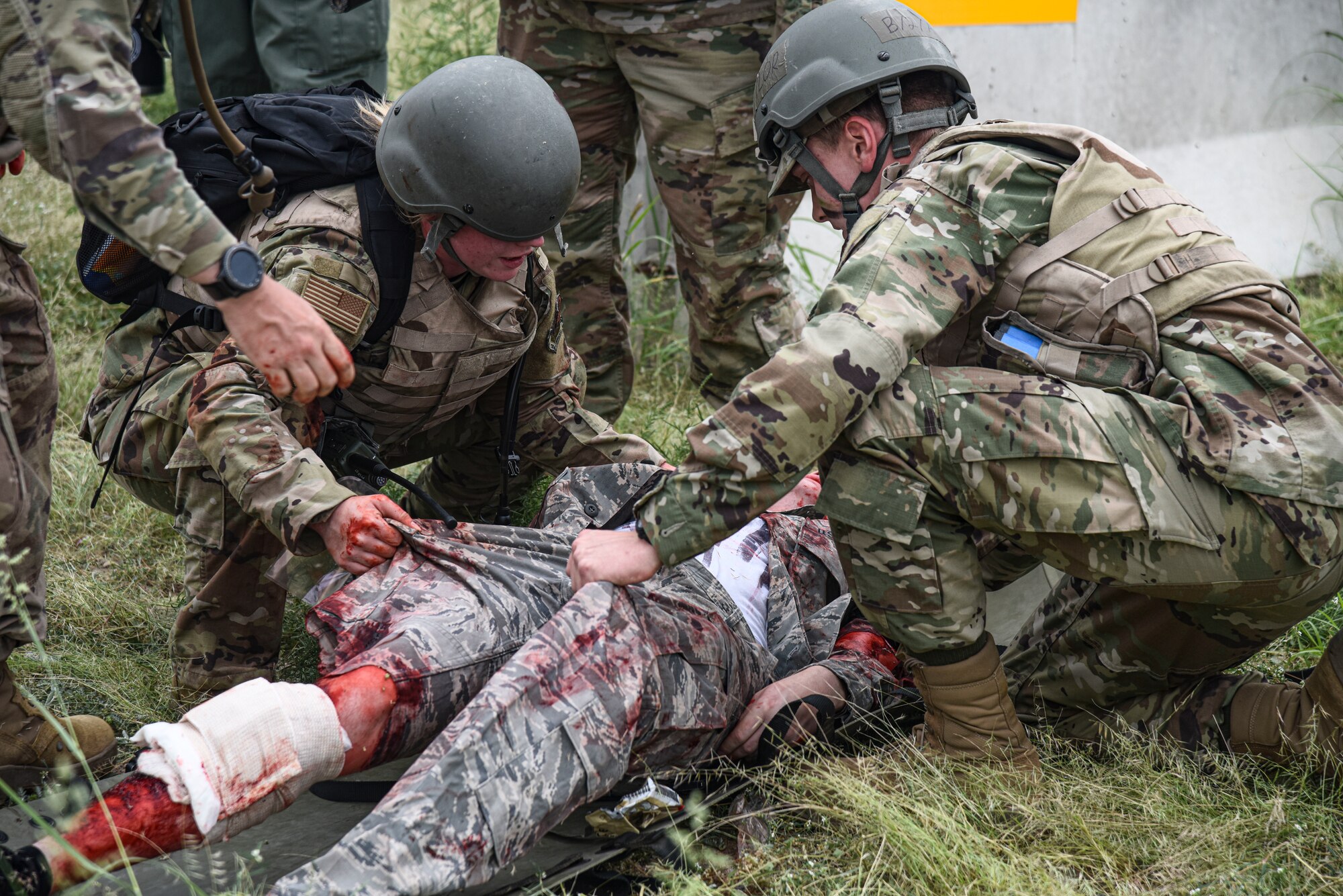 Pictured above is a small group of Airmen loading an injured person onto a medical carrying device.