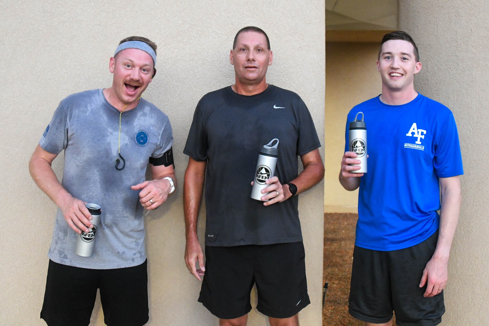 The top three runners from the National Preparedness Month 5k, U.S. Air Force Master Sgt. Kyle Adams, 97th Wing Staff Agencies first sergeant, Senior Master Sgt. Justin Stennes, 97th Civil Engineer Squadron (CES) assistant fire chief and 1st Lt. Tyler Stout, 97th CES project programmer, pose for a photo on Altus Air Force Base, Oklahoma, Sept. 1, 2021. The CES Emergency Management Flight organized several events throughout the month of September to encourage disaster awareness and preparedness . (U.S. Air Force Photo by Airman 1st Class Trenton Jancze)