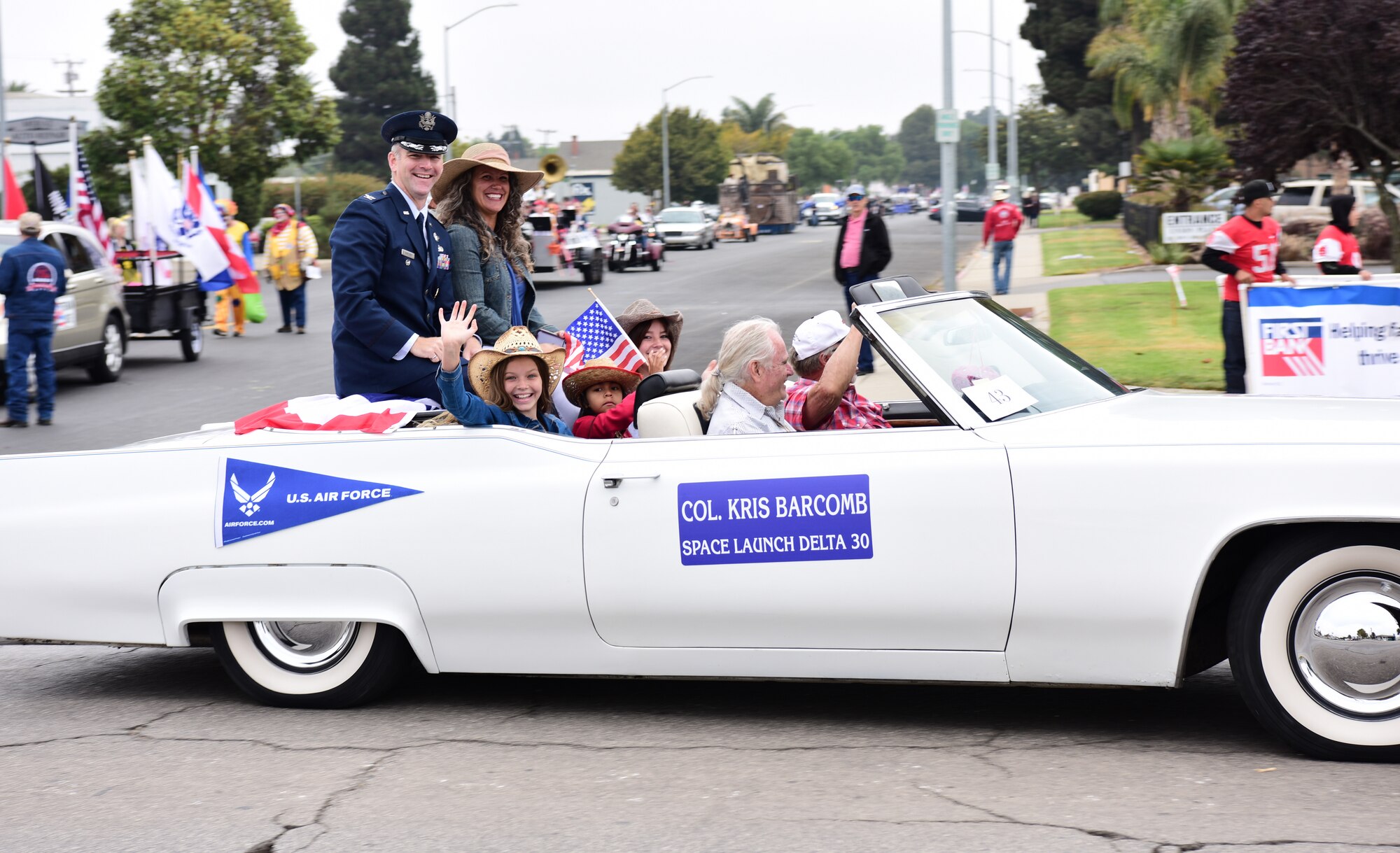 Col. Kris Barcomb, vice commander of Space Launch Delta 30 at Vandenberg Space Force Base, rides and waves to the crowd with his wife and children at the Santa Maria Elks Parade in Santa Maria, Calif., Sept. 4, 2021.  (U.S. Space Force photo by Airman First Class Tiarra Sibley)