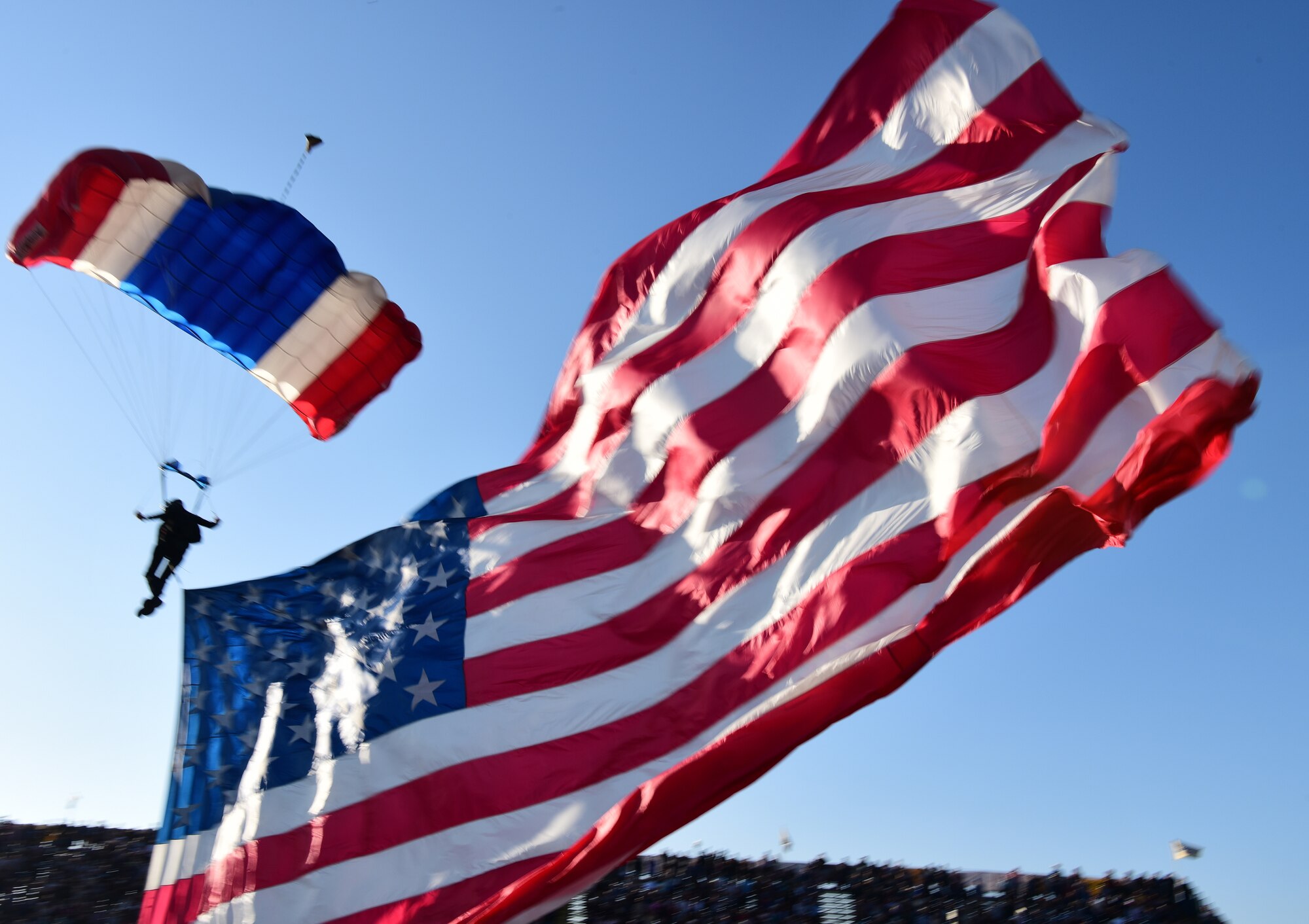 Skydiver, Kent Lane, soars down from the sky in the most patriotic way with the American flag at the Santa Maria Elks Rodeo in Santa Maria, Calif., Sept. 4, 2021. (U.S. Space Force photo by Airman First Class Tiarra Sibley)