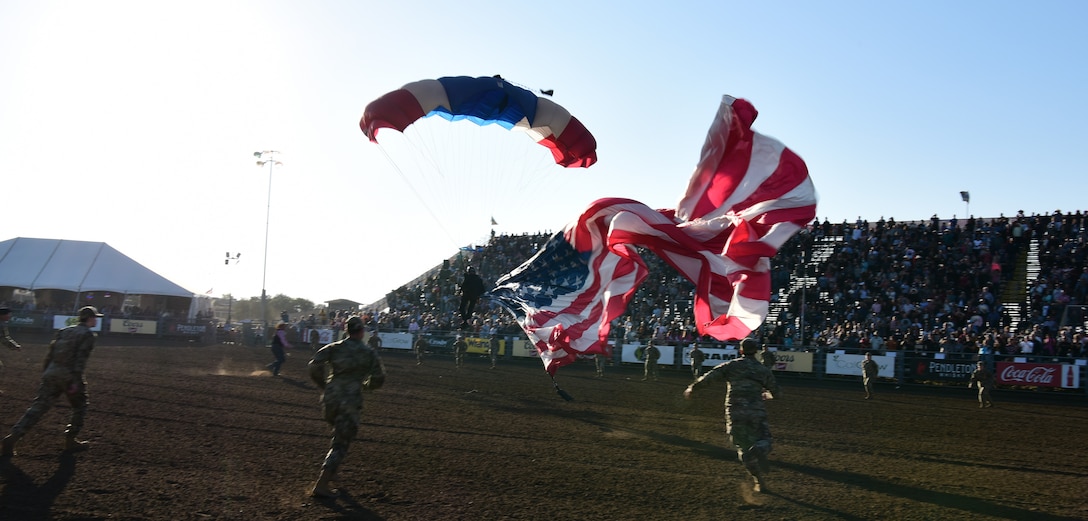Airmen and Guardian volunteers from Vandenberg Space Force Base quickly run to capture the flag before it hits the ground at the Santa Maria Elks Rodeo, Sept. 4, 2021. (U.S. Space Force photo by Airman First Class Tiarra Sibley)