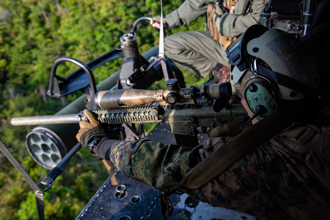 U.S. Marine Corps Cpl. Ryan Lauritsen, a scout sniper with 3d Battalion, 3d Marine Regiment, engages a target during aerial sniper training at Camp Hansen, Okinawa, Japan, March 17, 2021. The training increased the Marines’ precision from a moving aircraft. 3/3 is forward-deployed in the Indo-Pacific under 4th Marine Regiment, 3d Marine Division. Lauritsen is a native of Pontiac, Illinois. (U.S. Marine Corps photo by Staff Sgt. David Staten)